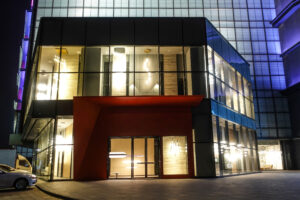 A building with many windows at night time.