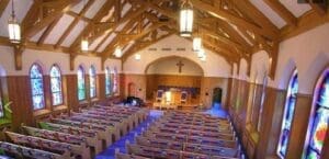 A church with many pews and chairs in it