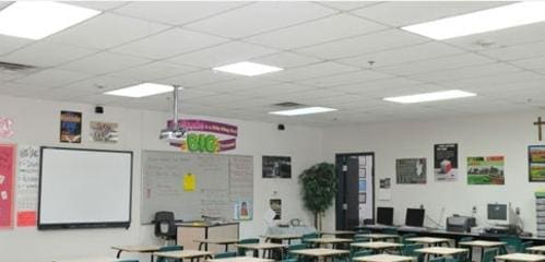 A classroom with many tables and chairs in it