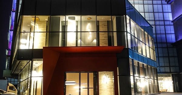 A building with many windows at night time.