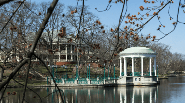 A gazebo sits in the middle of a lake.