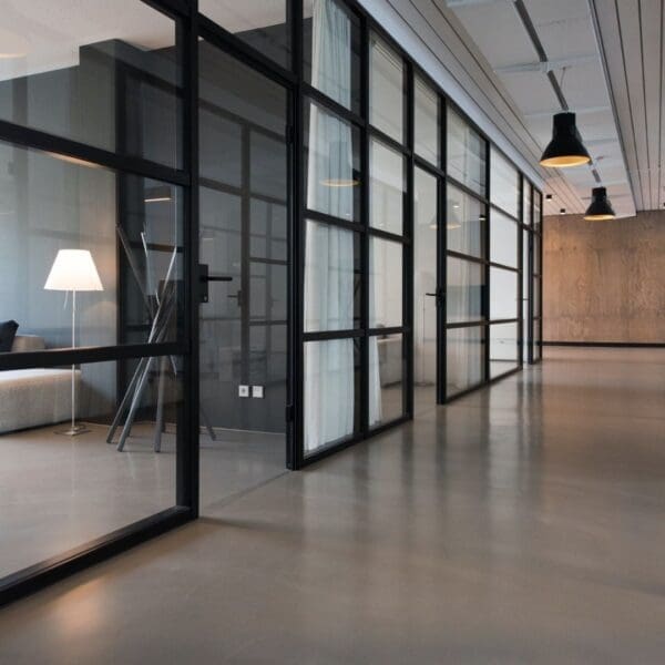 A room with glass walls and a table in the middle.