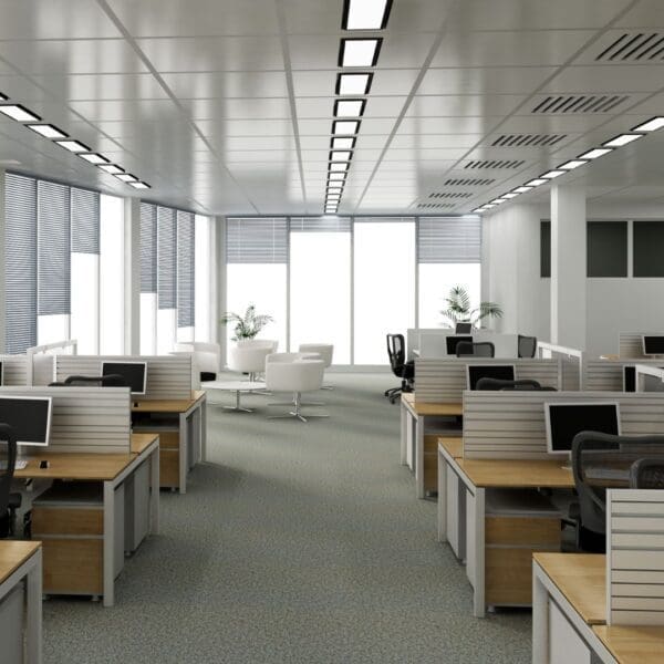 A large open office with many desks and chairs.