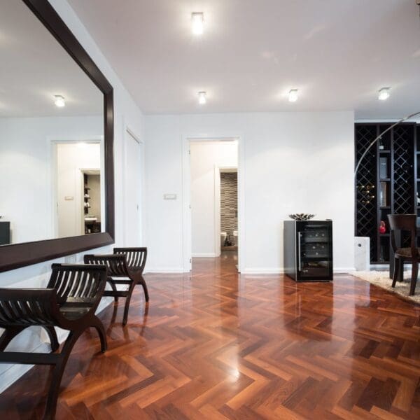 A room with wooden floors and chairs in it