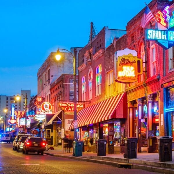 A street with many neon lights and buildings