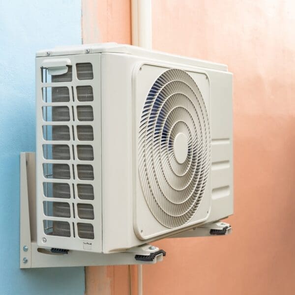 A white air conditioner mounted on the side of a wall.