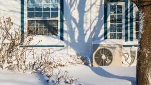 A house with snow on the ground and a window