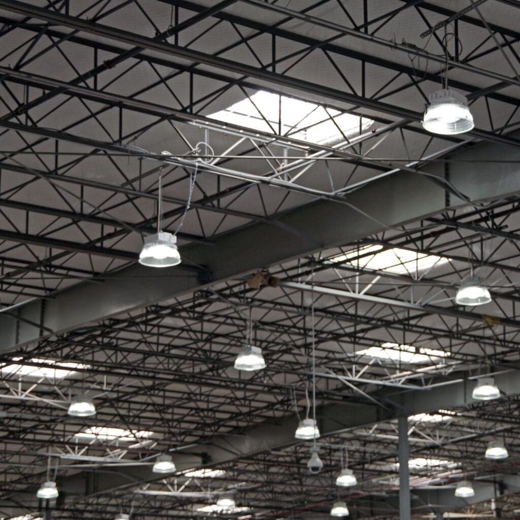 A large warehouse with many lights hanging from the ceiling.