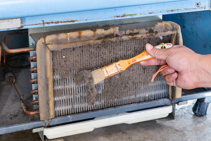 Dusty HVAC grill being cleaned