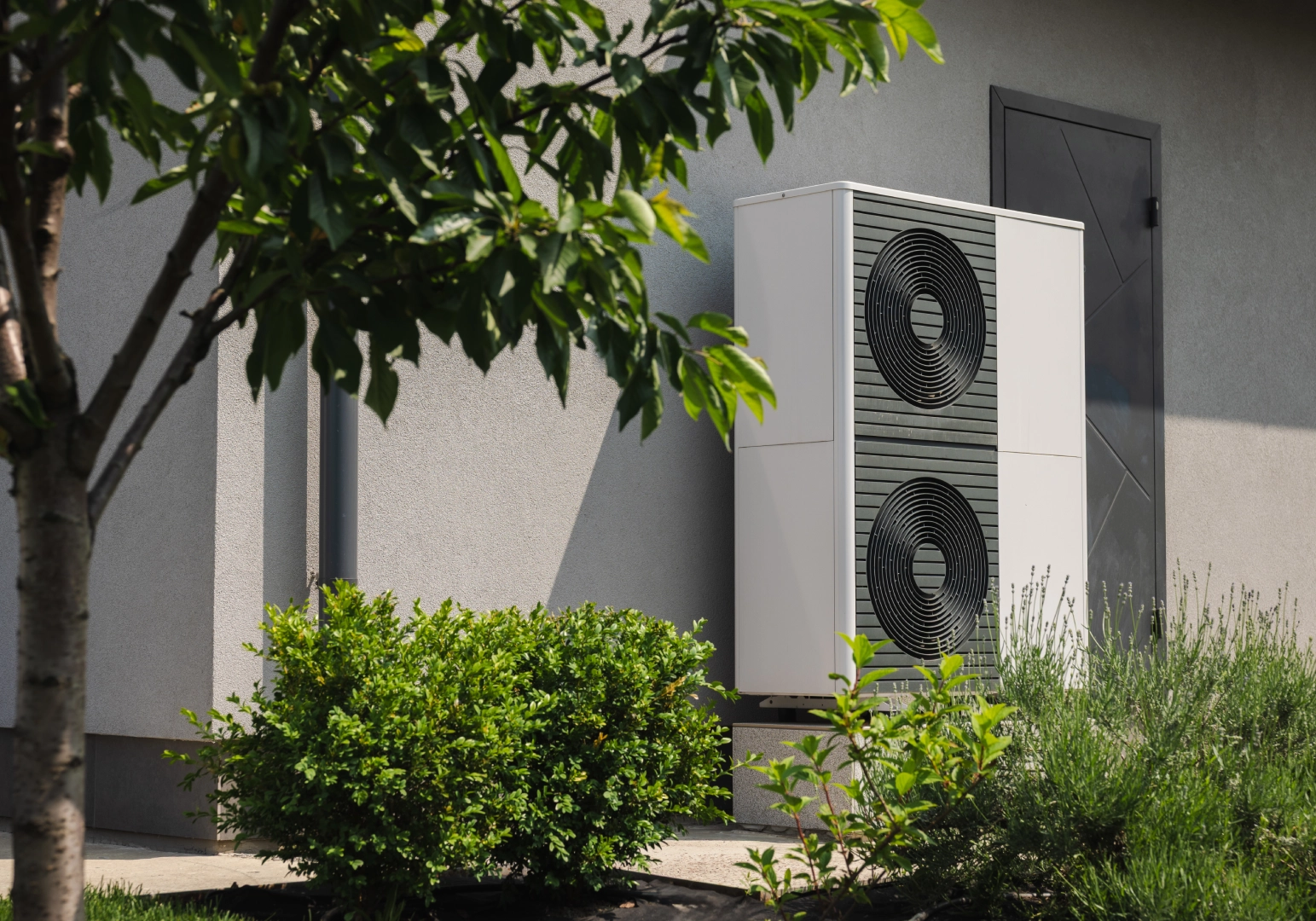 Modern heat pump with greenery nearby