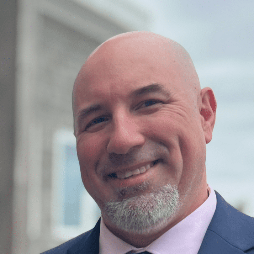 A man with a beard and a suit on.